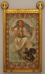 Female figure holding a circle in her left hand and coloured ribbons in her right hand with an ivy headdress sitting in a decorative halo with a bird of prey at her feet