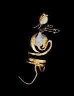 Gold snake wrapped around three times with a stylised blue face attached to a chain with a second snake face motif