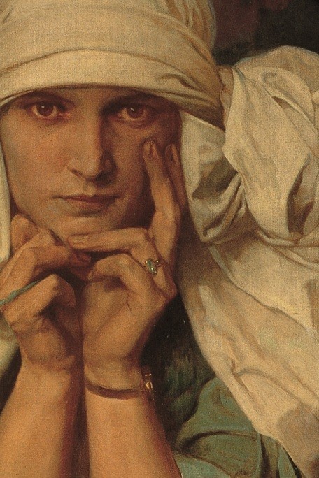 Close-up of a girl in a white headdress resting her head in her hands