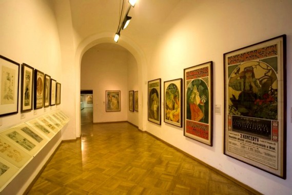 Mucha Museum, Prague A museum room with a selection of Mucha's colour lithographs on the right and plates from Documents décoratifs on the left