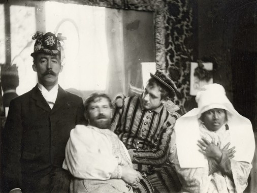 Mucha with his friends in the studio, Rue de la Grande Chaumière, Paris Mucha stands next to Gauguin who wears a decorated hat, Marold who is dressed in a stripey suit, and Anna La Javanaise who wears a Breton headdress