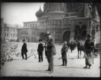 Mucha standing in the middle of the square sketching with boys looking on and St. Basil's cathedral behind