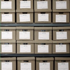 Series of cardboard archive boxes on a shelf