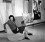 Peggy Guggenheim Peggy Guggenheim sitting in a modern chair in her gallery in front of two contemporary paintings