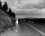 Cindy Sherman:  Untitled Film Still #48 Woman standing at the side of a road with her back to the viewer